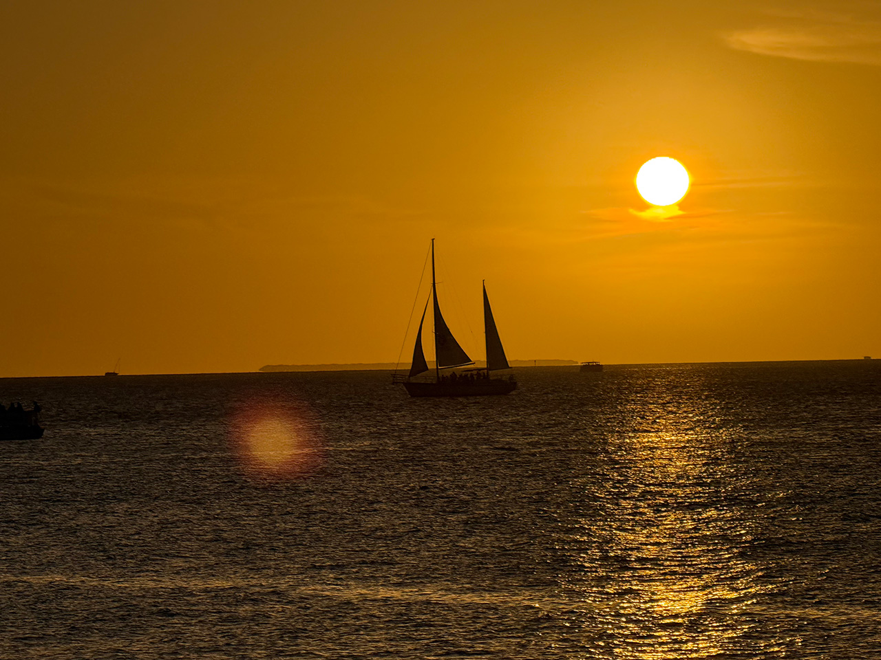 A sailboat in Key West on the ocean at sunset