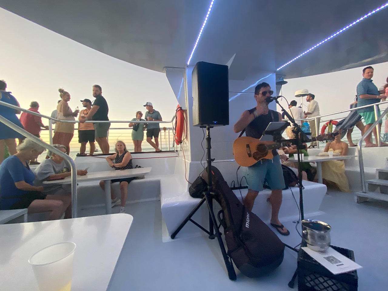 People in Key West on a sunset cruise watching a musician perform